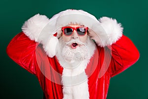 Closeup headshot photo of pensioner grandpa grey beard open mouth hands head shocked oversleep christmas eve wear red