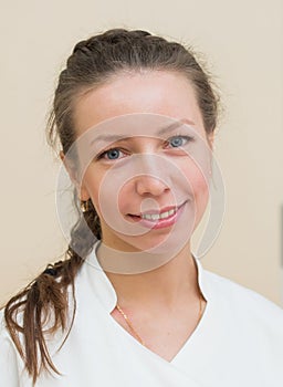 Closeup headshot portrait of friendly, smiling, confident female, woman doctor, looking at camera.