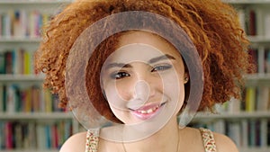 Closeup headshot and series collage of young, funky, cool woman laughing and smiling. Composite face portrait of afro