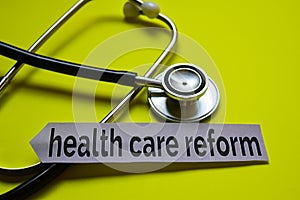 Closeup health care reform with stethoscope concept inspiration on yellow background