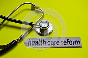 Closeup health care reform with stethoscope concept inspiration on yellow background