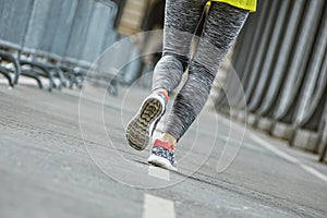 Closeup on healthy woman jogging on Pont de Bir-Hakeim bridge