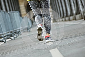 Closeup on healthy woman jogging on Pont de Bir-Hakeim bridge