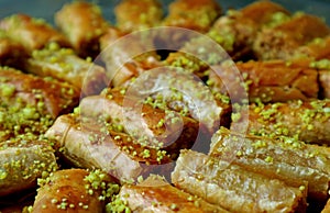 Closeup Heap of Baklava Pastries Topped with Chopped Pistachio Nuts