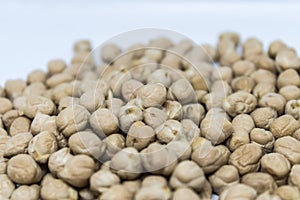 Closeup of heap of cheak peas, chick pea Cicer arietinum on white background