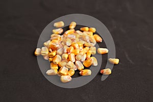 Closeup of a heap of corn grain isolated on a black background