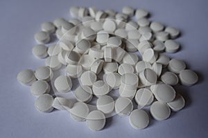 Closeup of heap of white tablets of vitamin K2