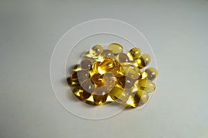 Closeup of heap of yellow softgel capsules of vitamin A retinyl palmitate