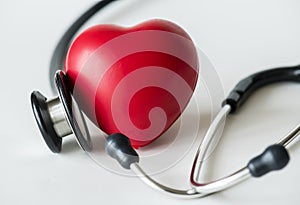 Closeup of heart and a stethoscope cardiovascular checkup concept photo
