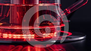 A closeup of the heating element on an electric kettle glowing red as it rapidly heats up the water inside