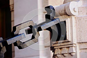 Closeup of heavy black steel chain links of square section