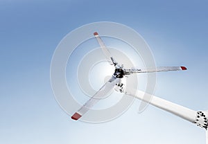 Closeup of helicopter tail rotor blade mechanism against blue sky