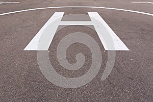 Closeup of helipad for landing helicopters on asphalt ground