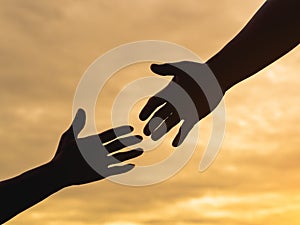 Closeup helping hands on the sunset sky background. Rescue & Help Cencept