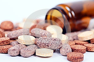 Closeup of herbal vitamin and supplement pills with herbs.