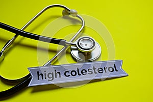 Closeup high colesterol with stethoscope concept inspiration on yellow background photo