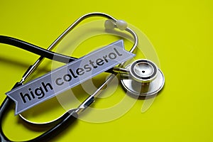 Closeup high colesterol with stethoscope concept inspiration on yellow background photo