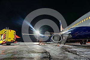 Closeup high detailed view of refueling operation of large widebody passenger aircraft standing on airport's parking place at photo