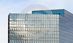 Closeup of high rise building glass sides in square pattern, reflectiong the sunlight photo