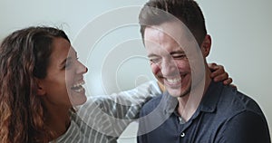 Closeup Hispanic couple in love embracing, telling jokes and laughing