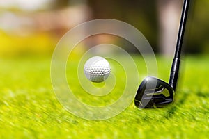 Closeup of hitting golf ball with golf iron club golf course wih motion blur effect