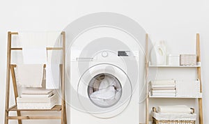 Closeup of home laundry room furniture with modern washing machine