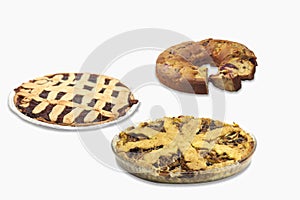 Closeup of homemade  apple, plum, and grape pies isolated on a white background