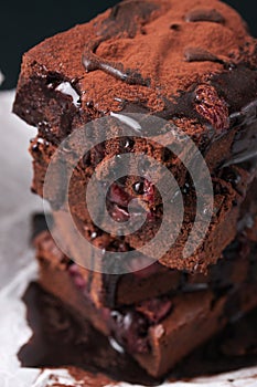 Closeup of homemade chocolate sweet brownies cakes with cherry and chocolate sauce or syrup