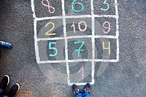 Closeup of hopscotch drawn with chalk on asphalt road. Children