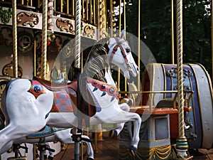 Closeup of a horse figure on a retro old-fashioned urban carrousel