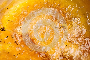 Closeup of hot bubbling boiling oil in a deep fryer photo