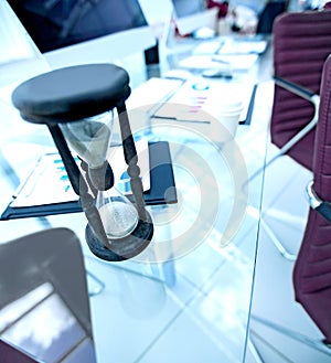 Closeup.the hourglass on the Desk of a businessman.