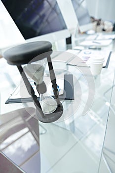 Closeup.the hourglass on the Desk of a businessman.