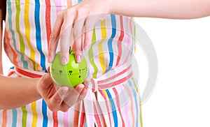 Closeup housewife or chef in kitchen apron using apple timer