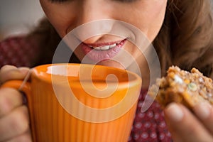 Closeup on housewife drinking tea with bread