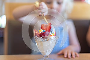 Closeup of ice cream sundae with strawberries and sprinkles