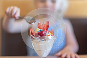 Closeup of ice cream sundae with strawberries and sprinkles