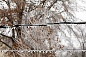 Closeup of ice on power line from freezing rain