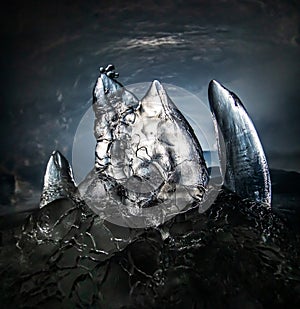Ice stalagmite in a dark cave photo