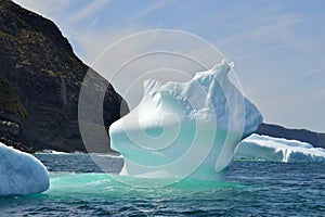 Closeup of iceberg in bay outside St. John\'s with bright turquoise colouration photo