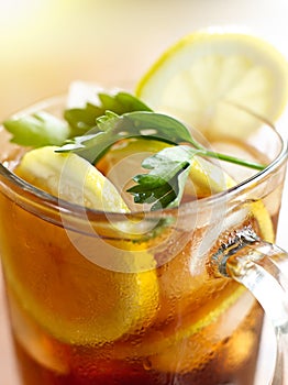 Closeup iced tea with lemon slice and leaf garnish photo