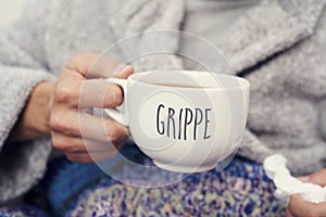 Ill man and mug with word grippe, flu in french