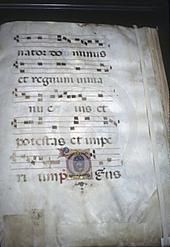 Closeup of an illuminated medieval manuscript on a  parchment with the historical Gregorian chant photo