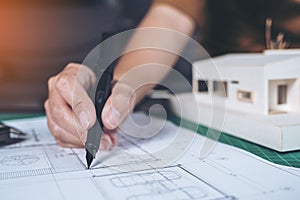 Closeup image of architects drawing shop drawing paper with mass model