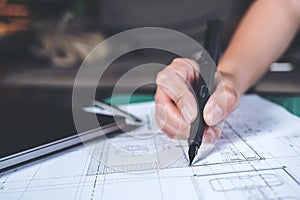 Closeup image of architects drawing shop drawing paper with mass model