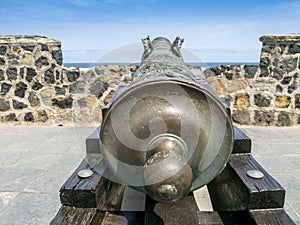 Closeup image of beautiful decorated ancient cannon on the wall of ocean fort or castle
