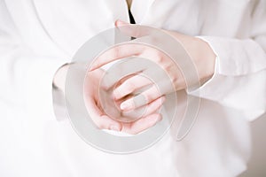 Closeup image of beautiful woman`s hands with light manicure on the nails. Cream for hands, manicure and beauty treatment