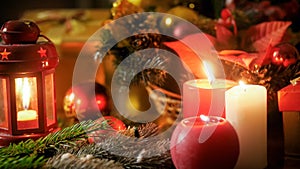 Closeup image of burning candles and Christmas decorations on wooden table. Perfect backgorund for winter holidays and