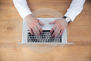 Closeup image of a businessman hands using laptop
