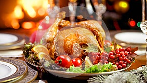 Closeup image of chicken baked with vegetable on family Christmas dinner nex tto fireplace